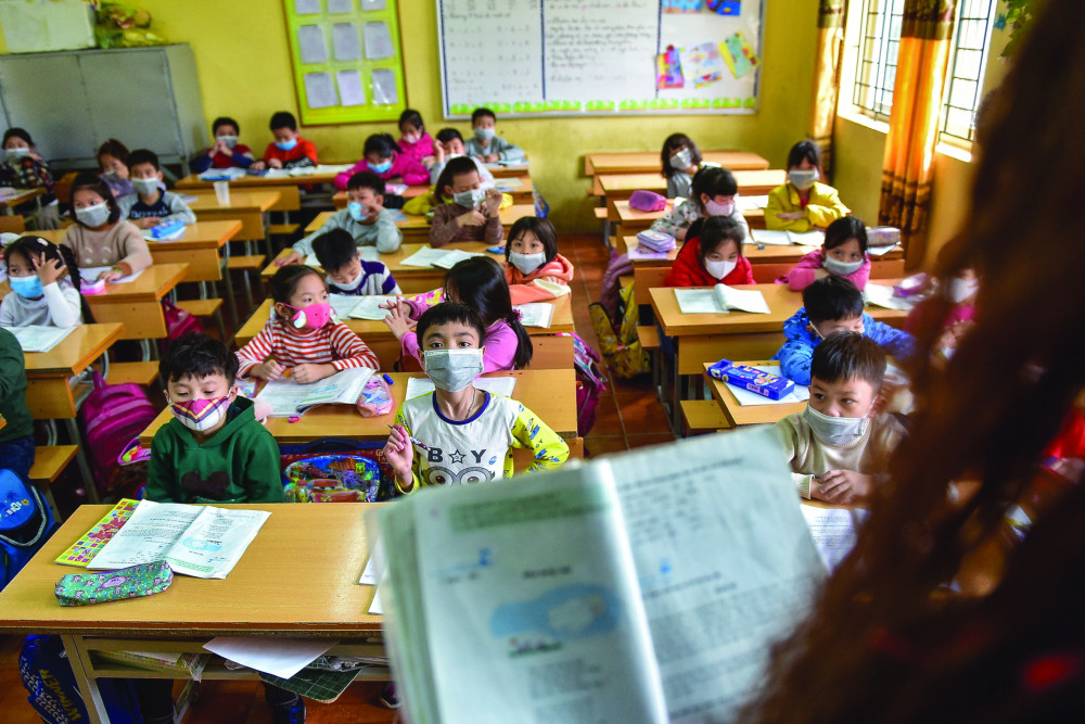 Học sinh Trường tiểu học Tả Thanh Oai (Hà Nội) đeo khẩu trang trong giờ học (ảnh chụp ngày 31/1/2020) - Ảnh: Toàn Vũ/Dantri