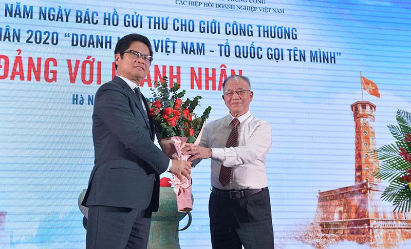 TS Vũ Tiến Lộc - Chủ tịch VCCI tặng hoa GS Hoàng Trí Bảo.