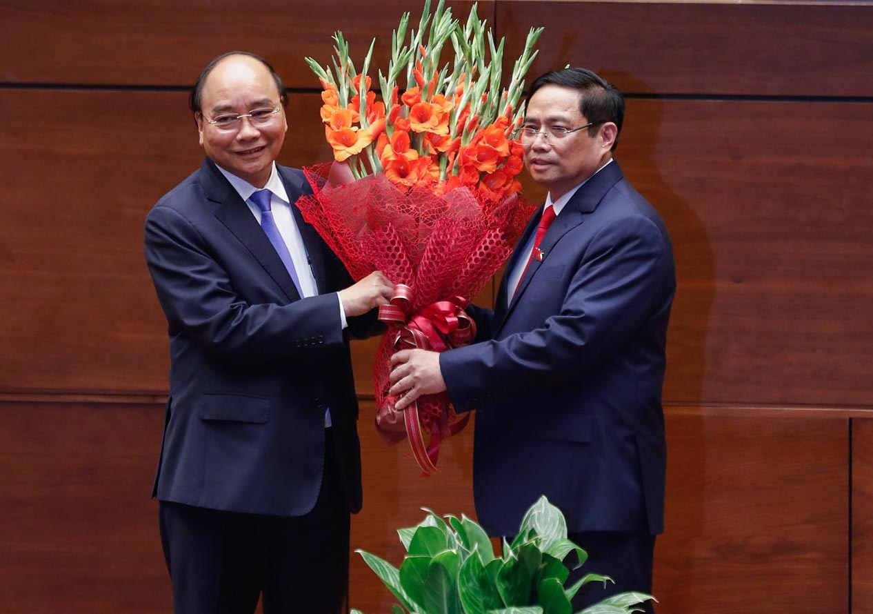 Chủ tịch nước Nguyễn Xuân Phúc tặng hoa chúc mừng Thủ tướng Chính phủ Phạm Minh Chính.
