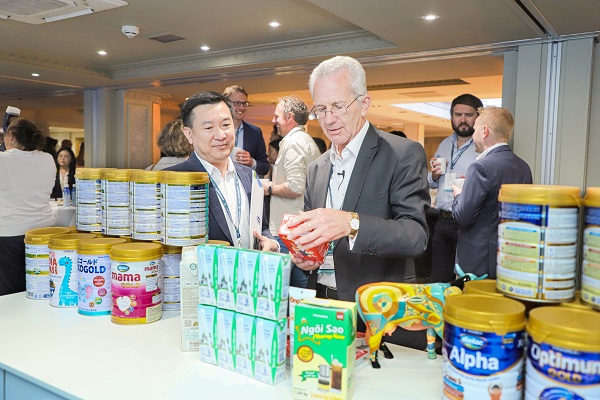 Ông Richard Hall, Chủ tịch Hội nghị sữa toàn cầu (bên phải) hào hứng tìm hiểu về các sản phẩm sữa của Vinamilk mang đến Hội nghị năm nay.