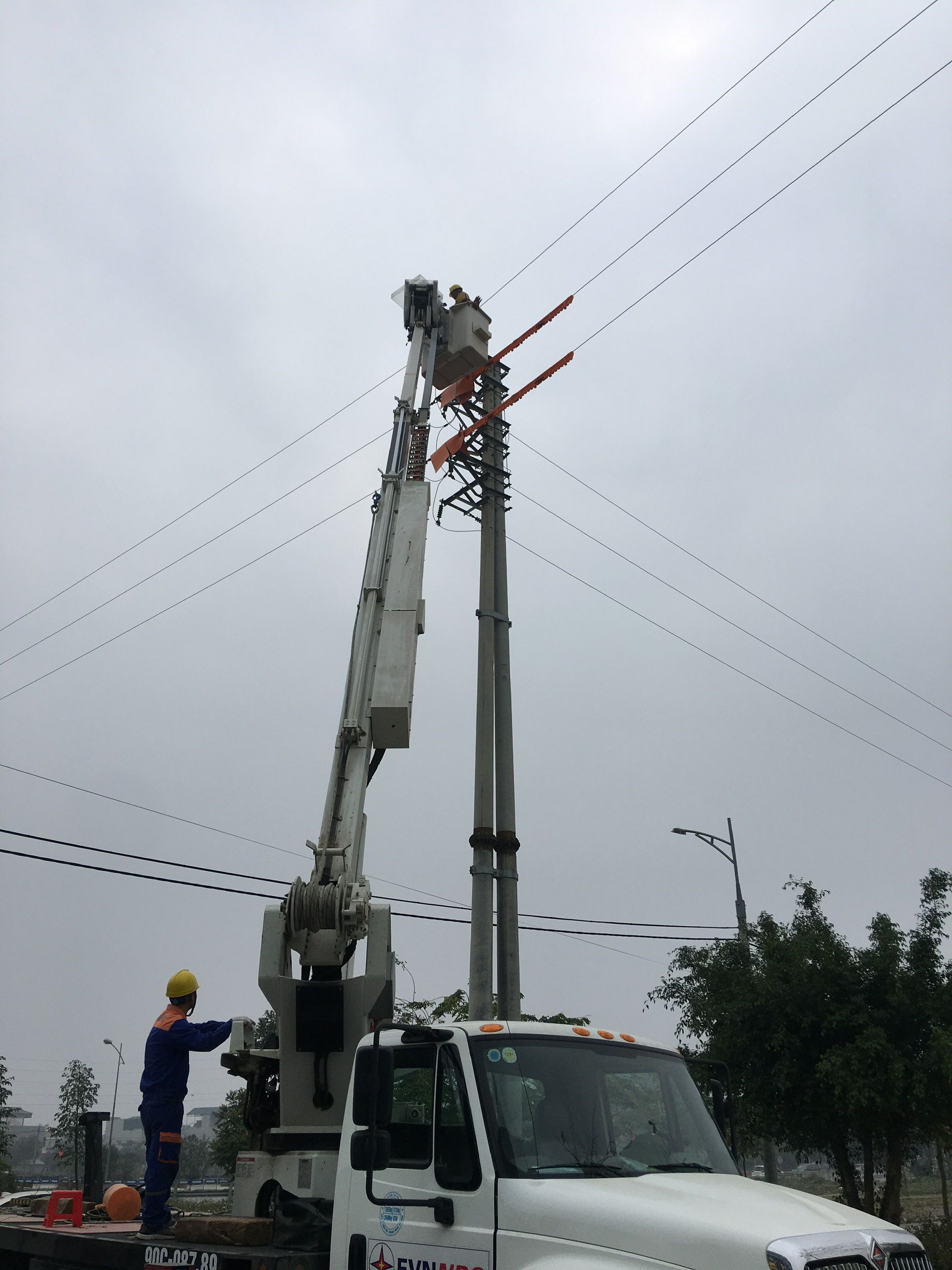 Đội thi công sửa chữa hotline Công ty Điện lực Hà Nam thực hiện công việc trên lưới điện 22kV đang mang điện.